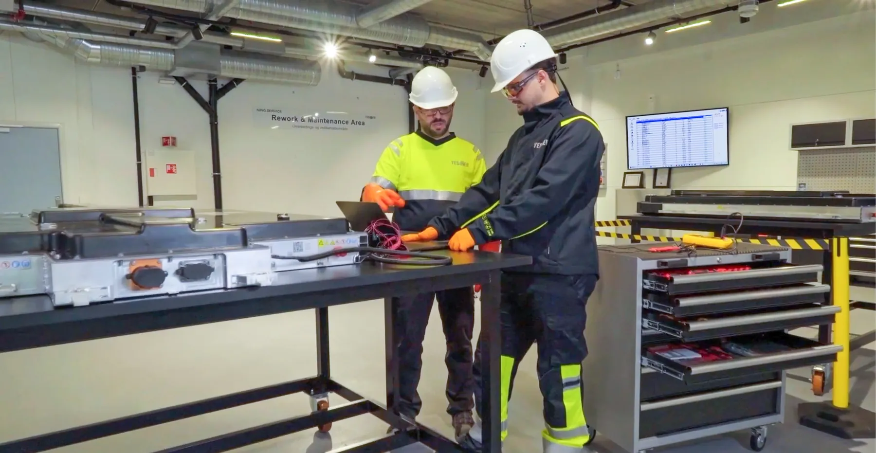 YES-EU technicians working on a battery in the rework and maintenance area