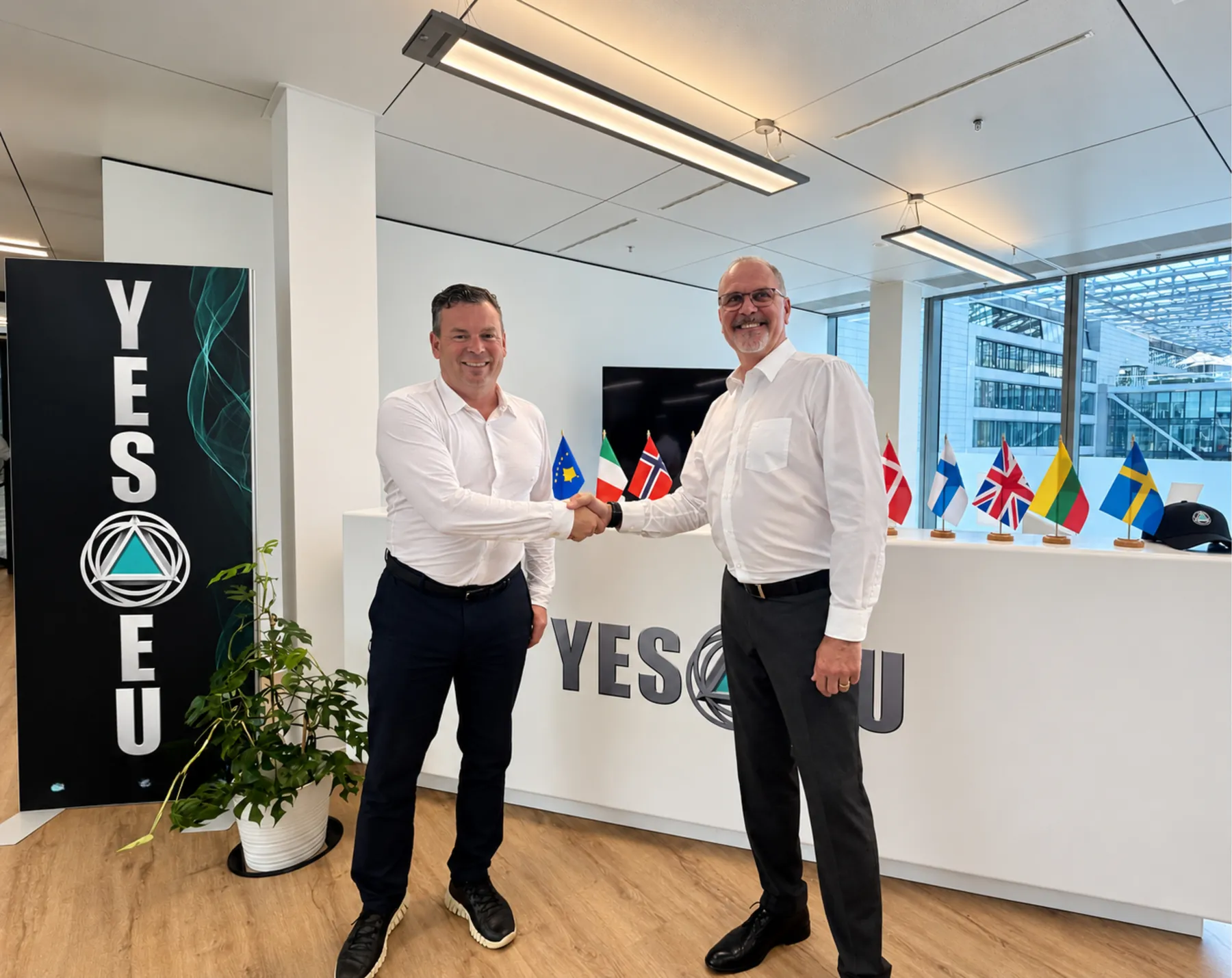 Benedikt G. Gudmundsson and Pierre Savoy shaking hands at a YES-EU office